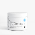 Jar of Bovine Colostrum powder on a white background