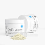Jar of bovine colostrum powder with open lid on a white background