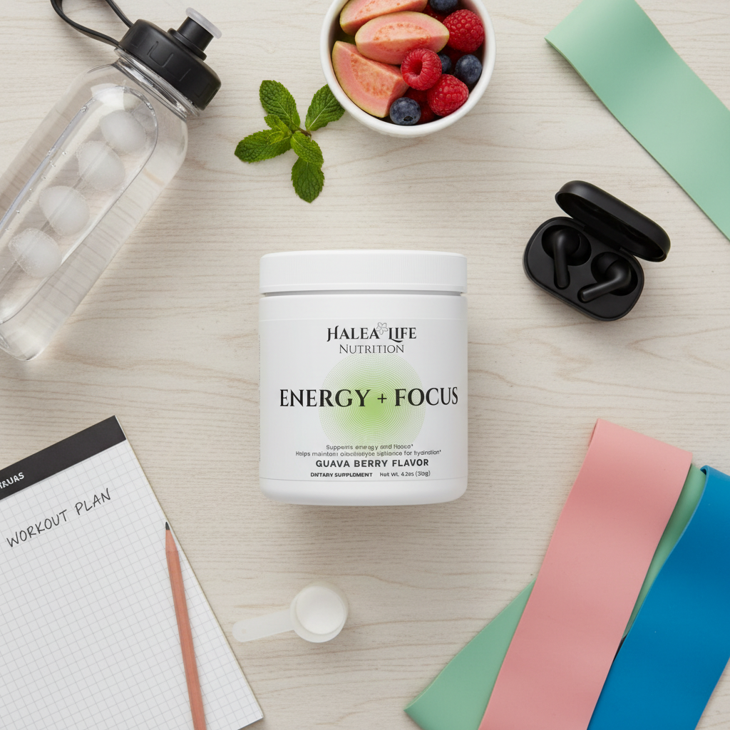 Halea Life Nutrition Energy + Focus supplement container on a table with a water bottle, fruit bowl, and exercise bands.