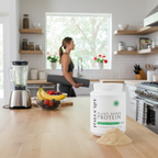 Halea life plant-based protein container on a kitchen counter with a woman exercising in the background