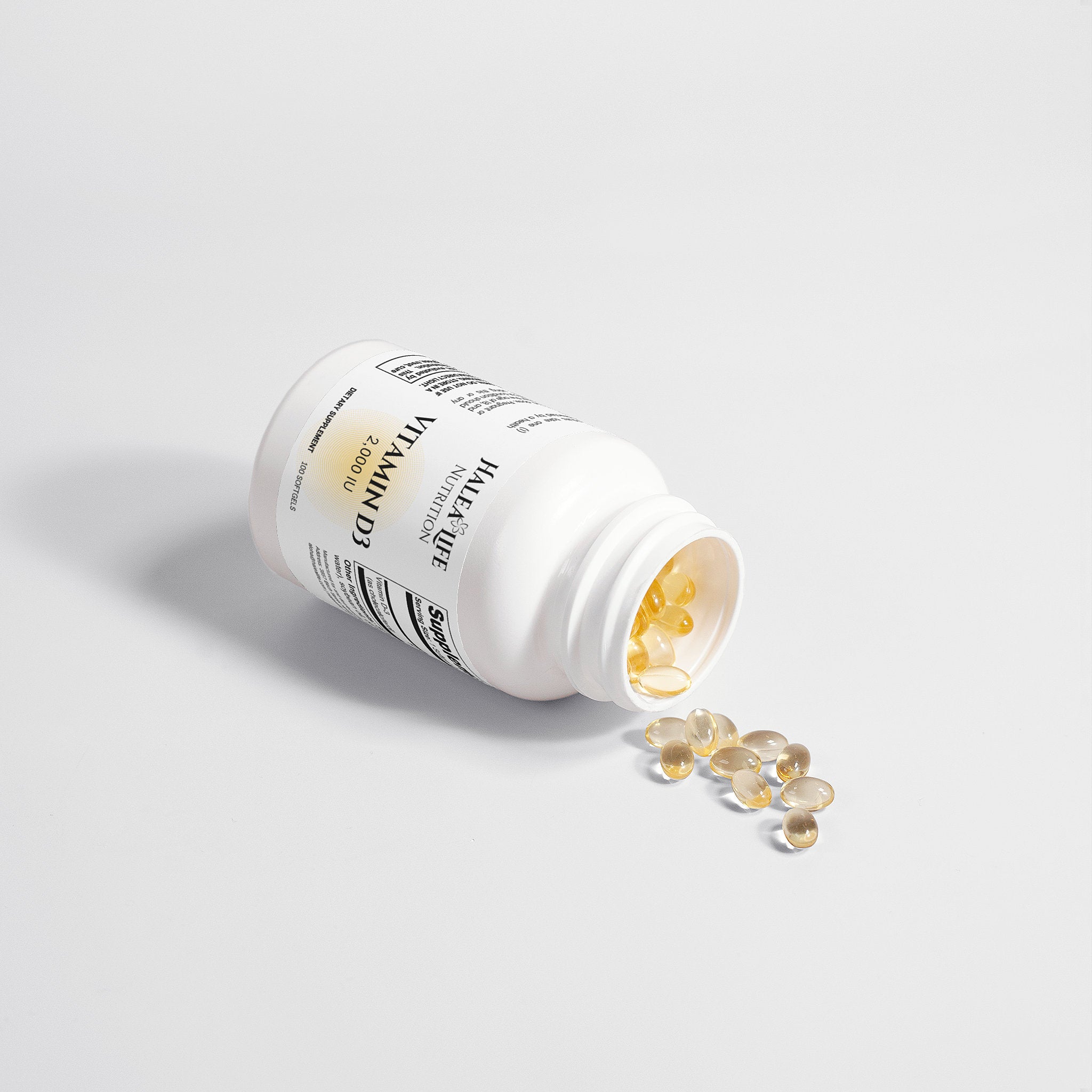 White supplement bottle with gold capsules on a light gray background